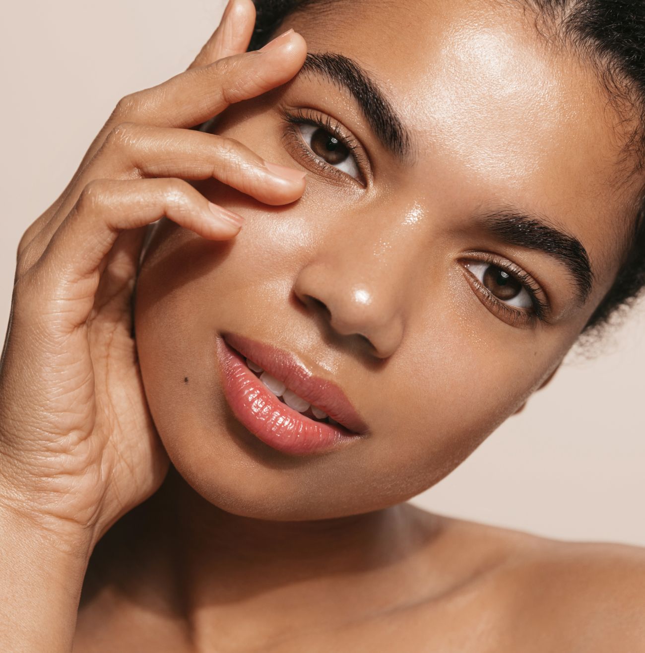 Close-up of woman with glowing skin.