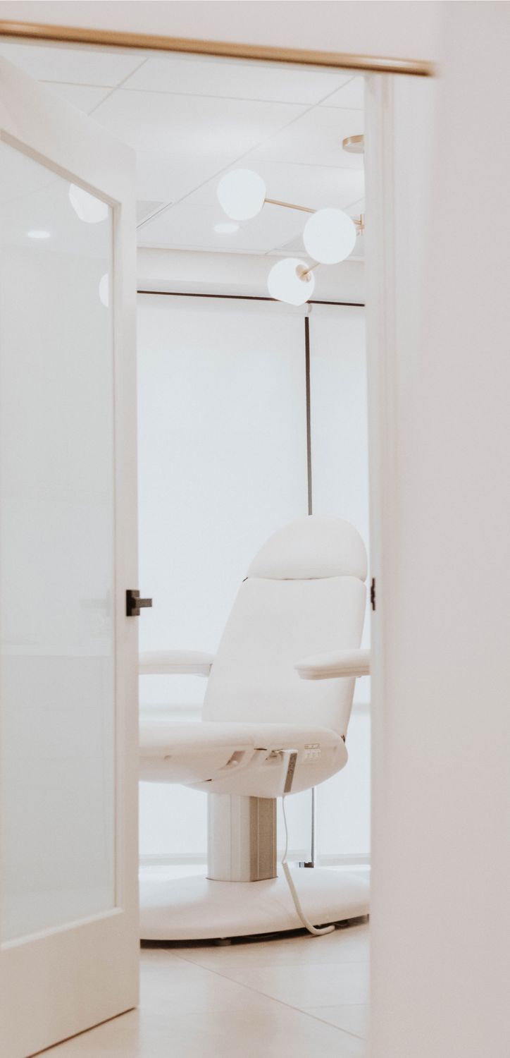 Modern dental chair in bright office setting.